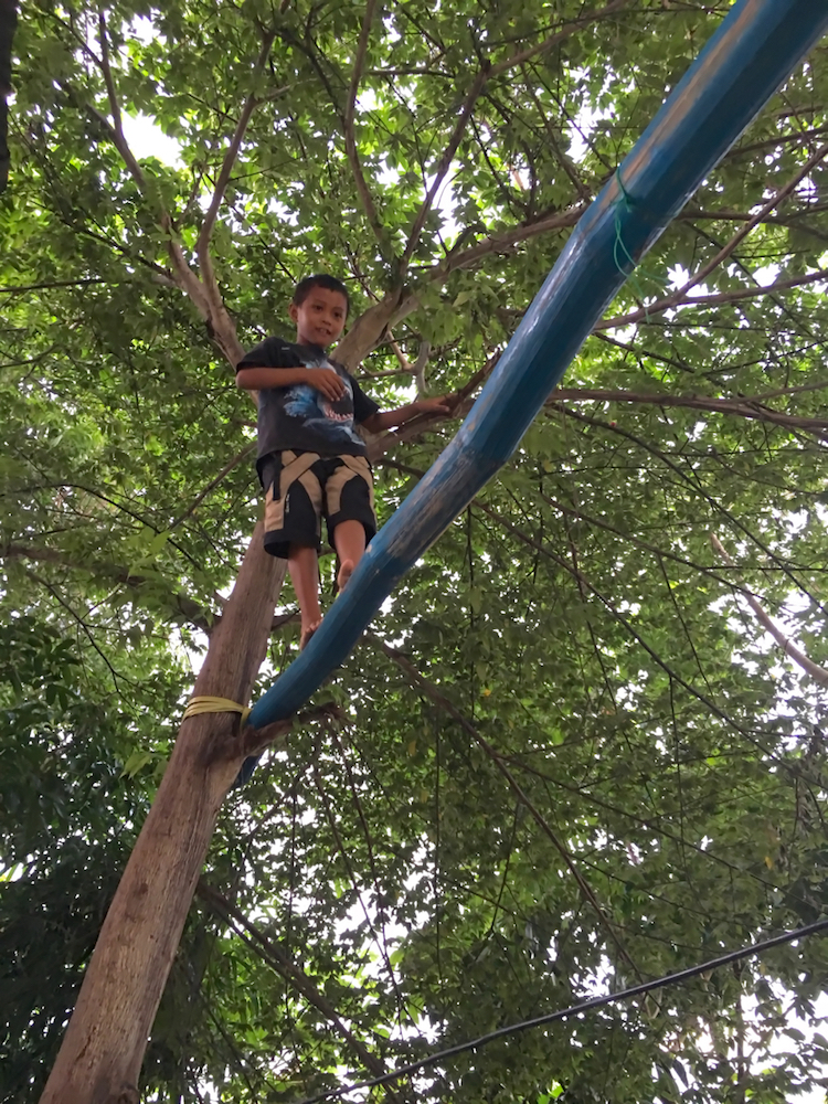 testing me out, he pretends he's gonna walk across that bamboo beam with no hands ...