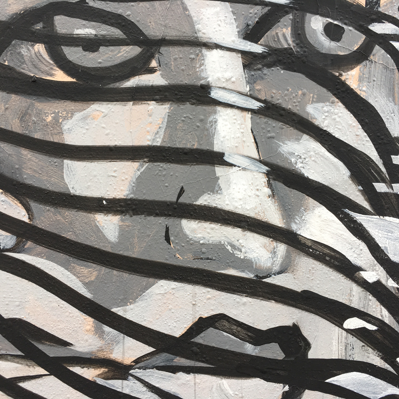 grayscale mural of a ladies face behind ribbonish stuff