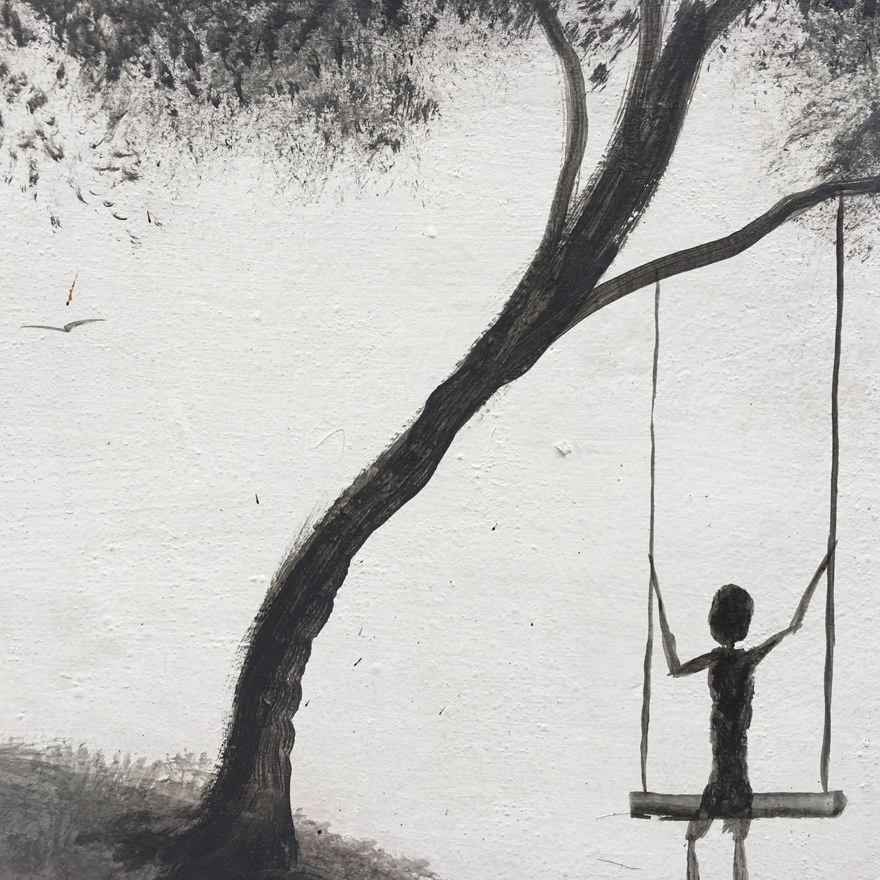 black and white mural of a figure on a swing under a tree