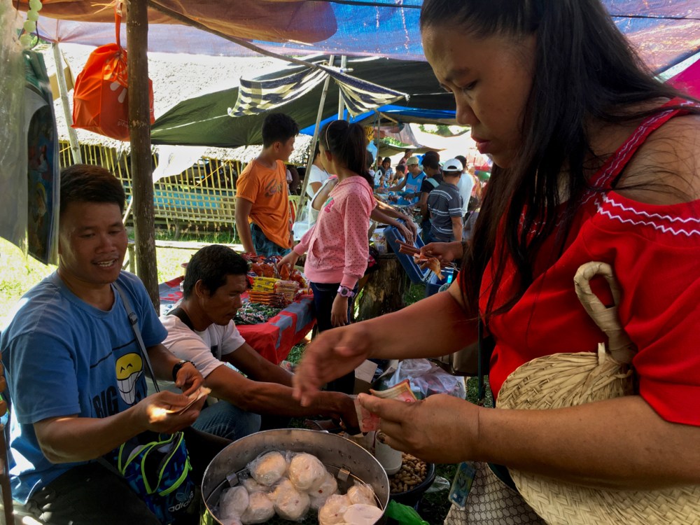 em buys siopai from a street vendor