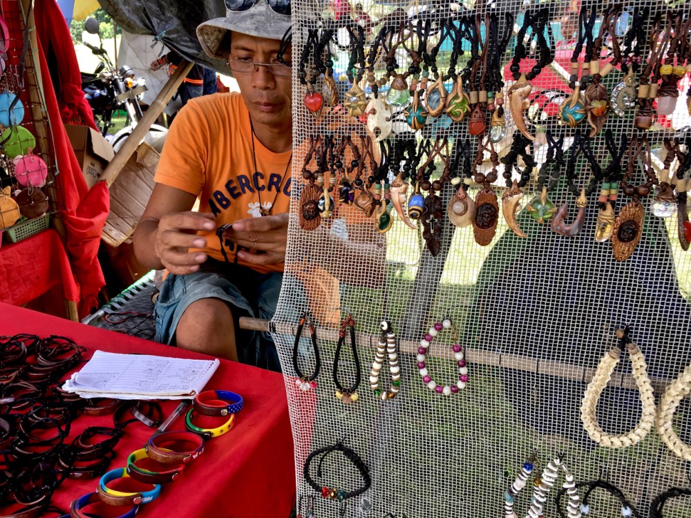 leather and jewellery craftsman at a local market