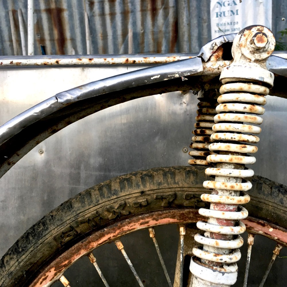 artistic photo of rusted metal and and an old bicycle