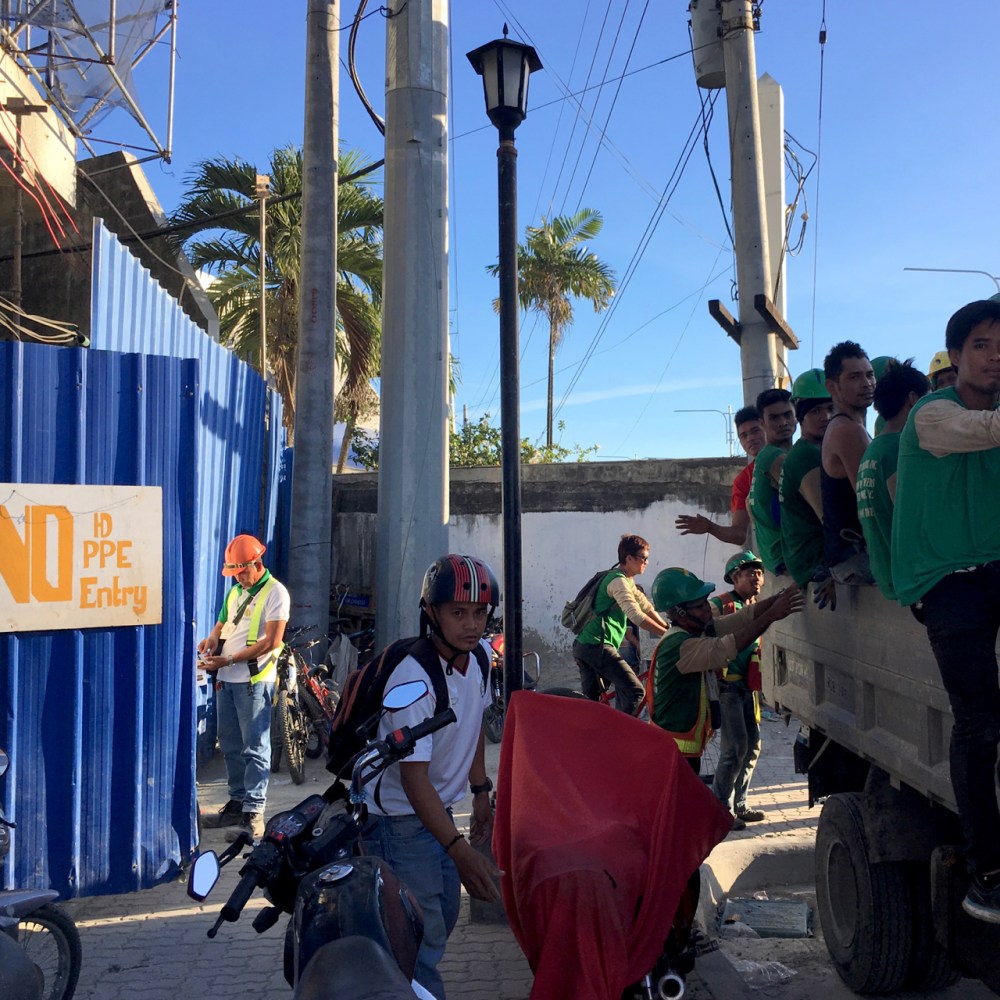workers leave a construction site in the Philippines