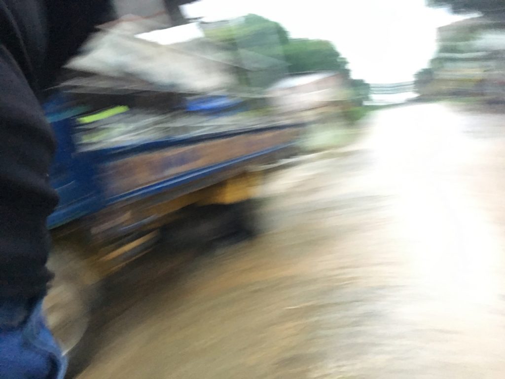 blurred street shot of mud and a truck