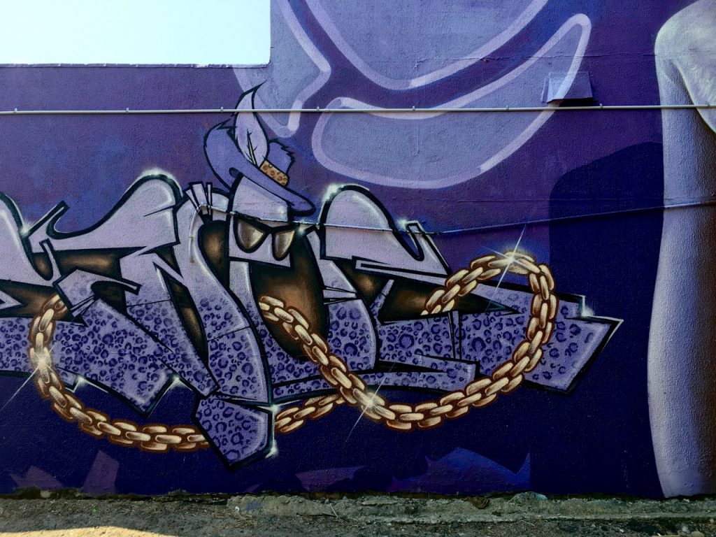 section of a purple street mural