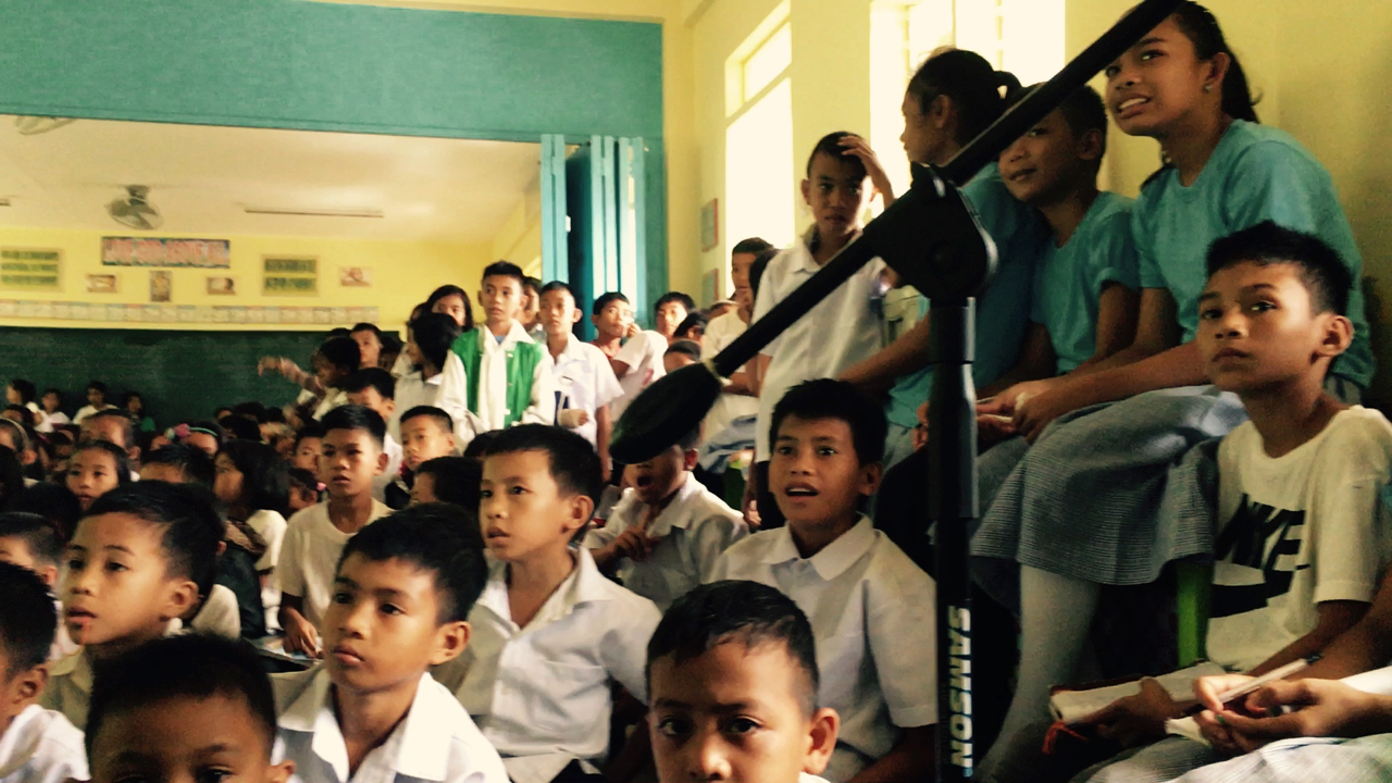 the children are delighed as a little turtle reaches the shore