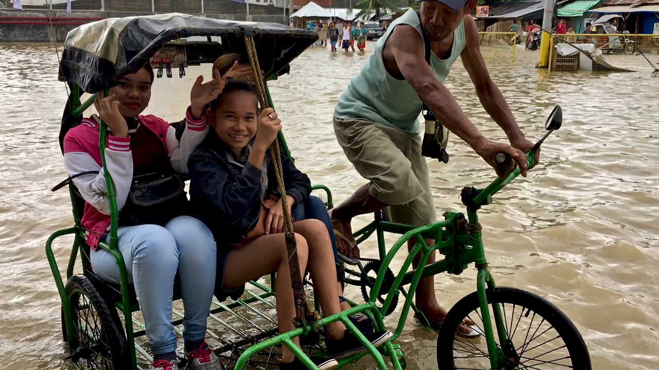 group of girls in floodwaters from Urduja, balasan philippines