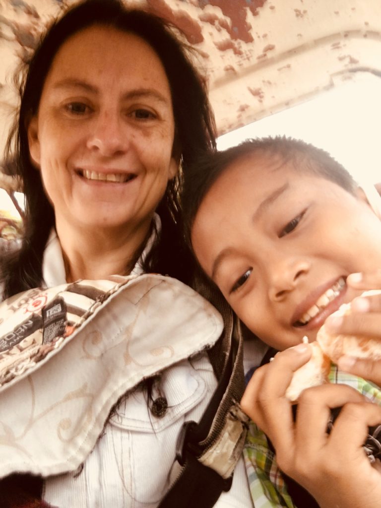 in the tricycle with his rescued orange