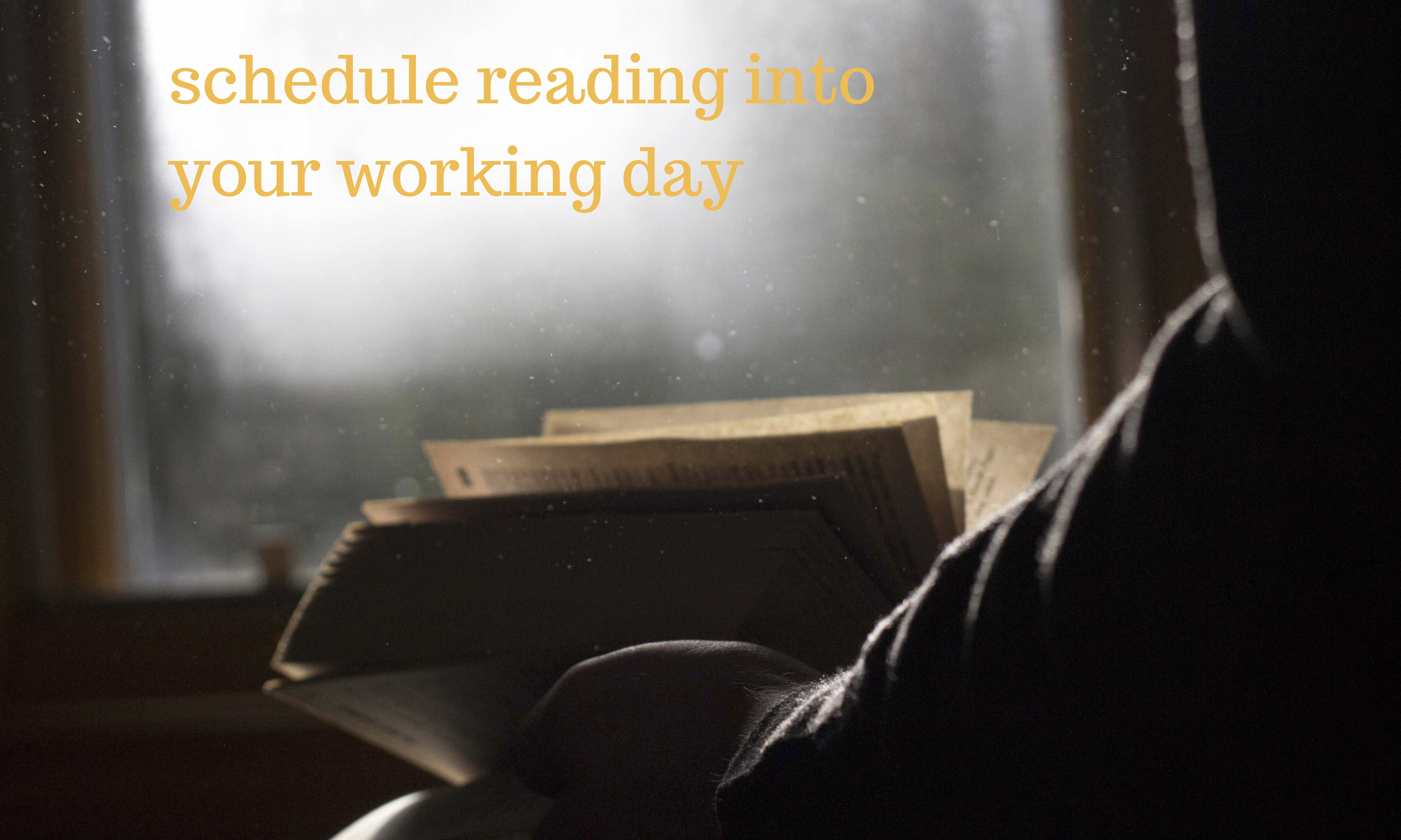 person reading in front a brightly lit window