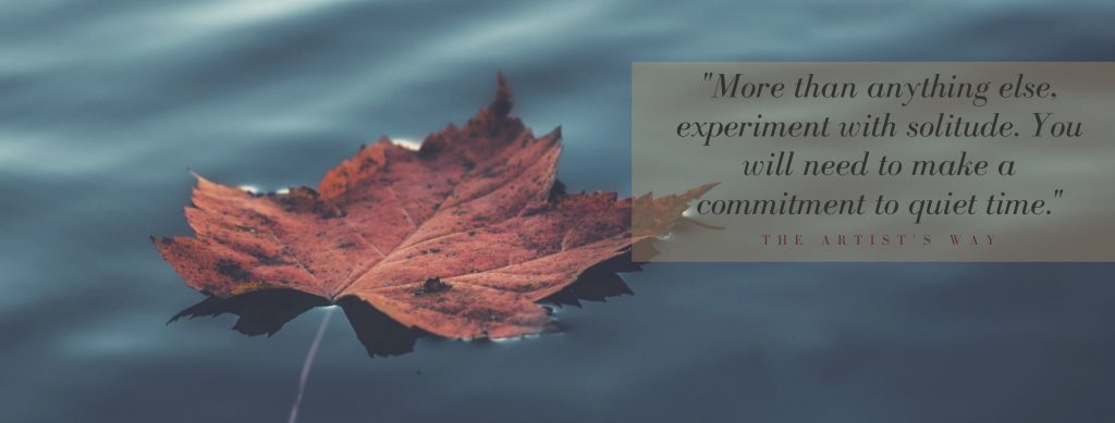 leaf on water with a quote