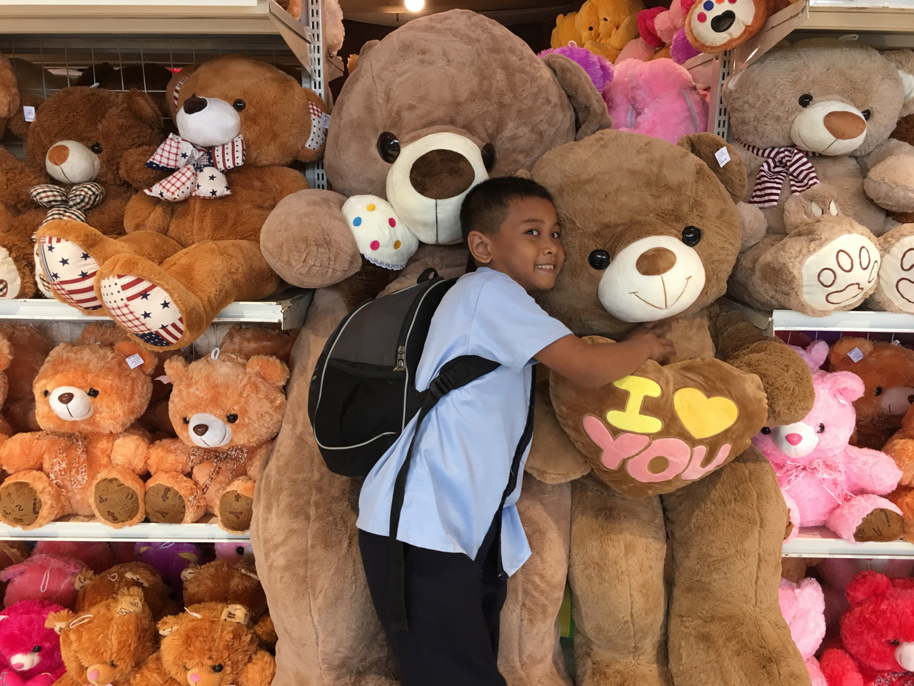 school boy with teddy bears